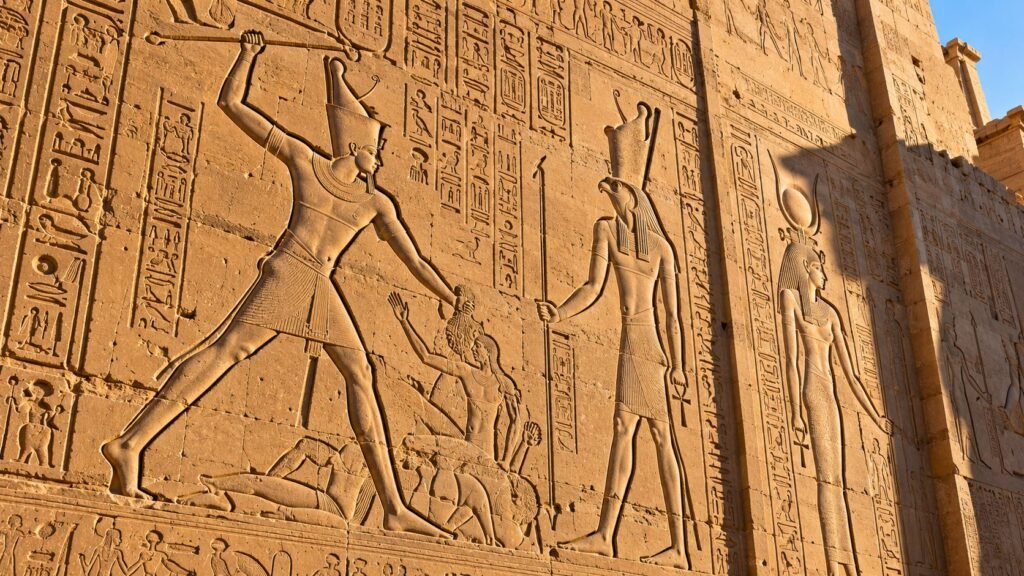 Carved reliefs on the pylon of Edfu Temple showing a king before the gods