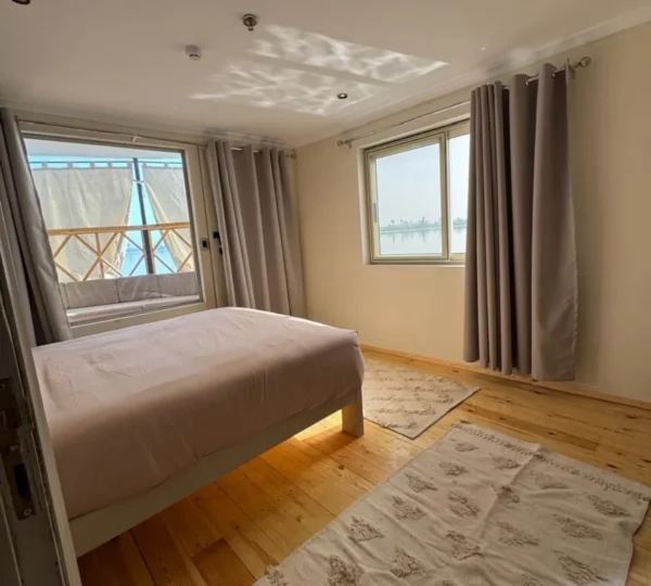 Luxury dahabiya bedroom with Nile River view in Egypt