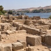 Ancient stone ruins on Elephantine Island with the Nile in the background