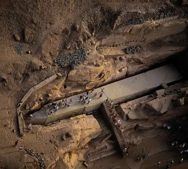 Visitors walking beside the Unfinished Obelisk in the granite quarry in Aswan